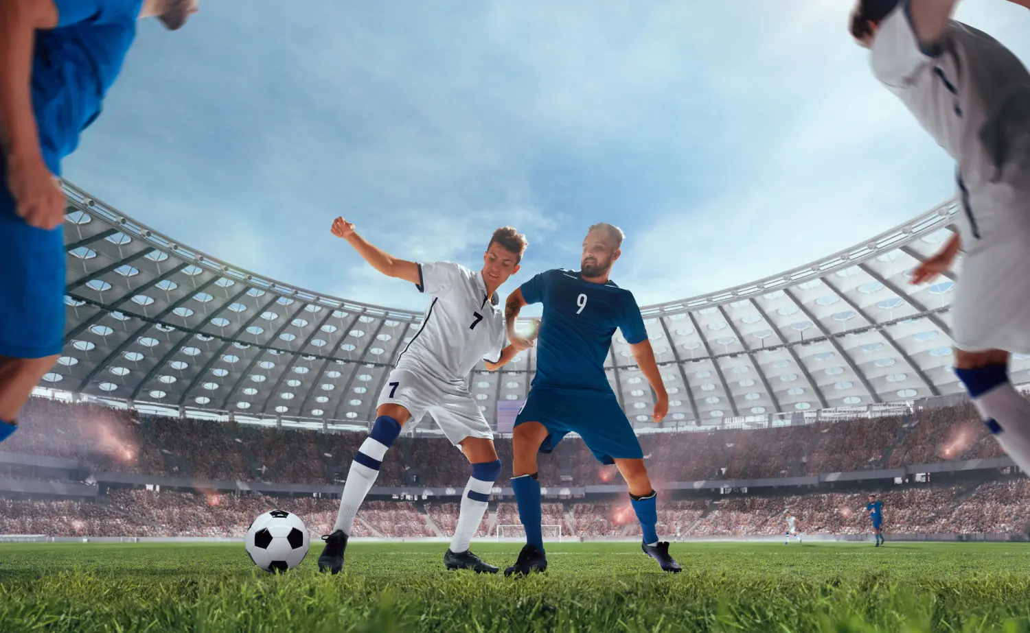 In a lively arena, two men compete in a soccer game, showcasing their skills and teamwork on the field.