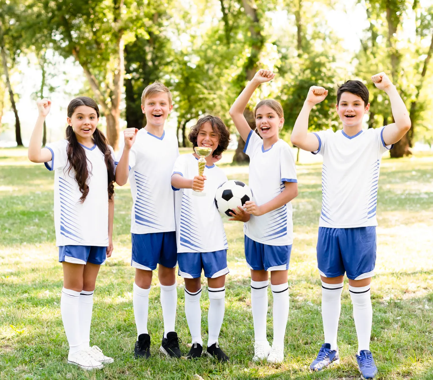 A group of children in soccer uniforms proudly holding a trophy, celebrating their victory together.
