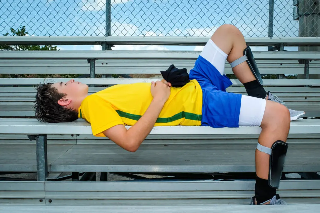 exhausted youth soccer player after a game laying down