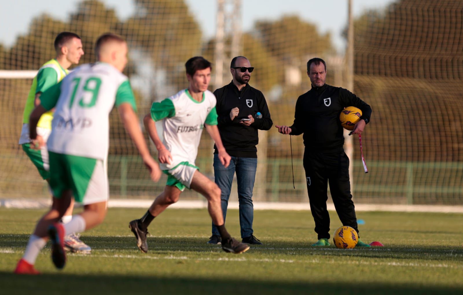 A lively scene of men participating in a soccer game on a field, showing their competitive spirit and teamwork.