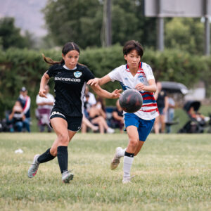 Girls playing for AYSO Section 1 Alliance in a competitive youth soccer pathway match