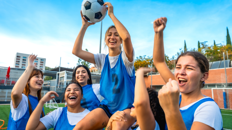 Youth soccer Financial Aid and Grants. Group of girls celebrating a goal.