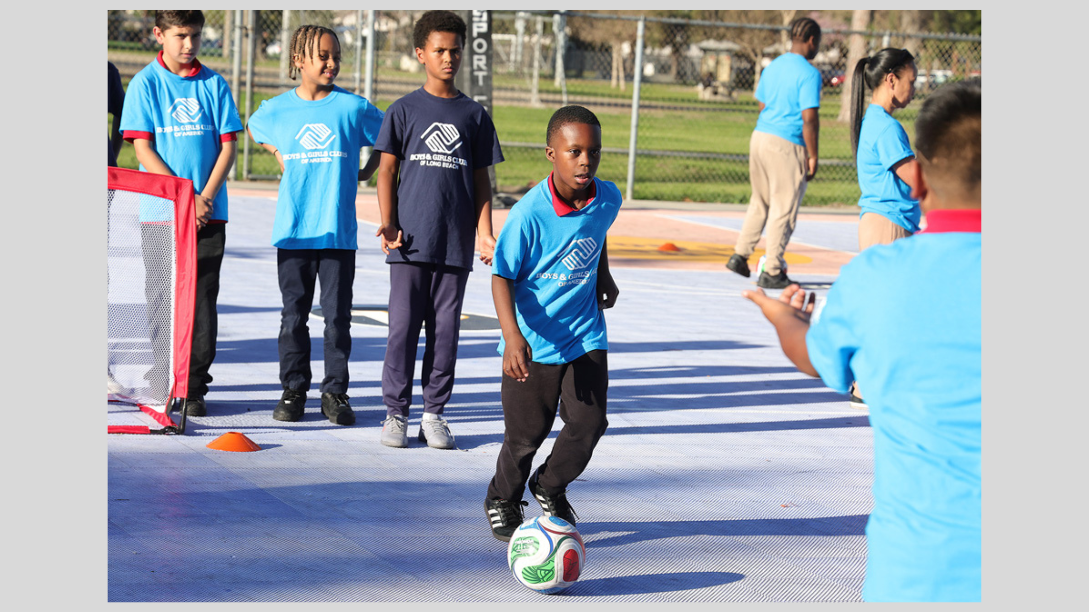 Boys & Girls Clubs of America youth soccer practice with kids playing on outdoor community court