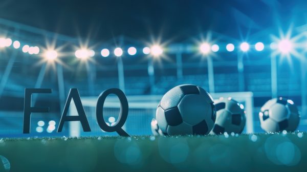 Soccer balls on a field at night with FAQ sign in background
