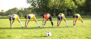 Soccer players lined up on the field, demonstrating unity and focus as they prepare for the upcoming game.